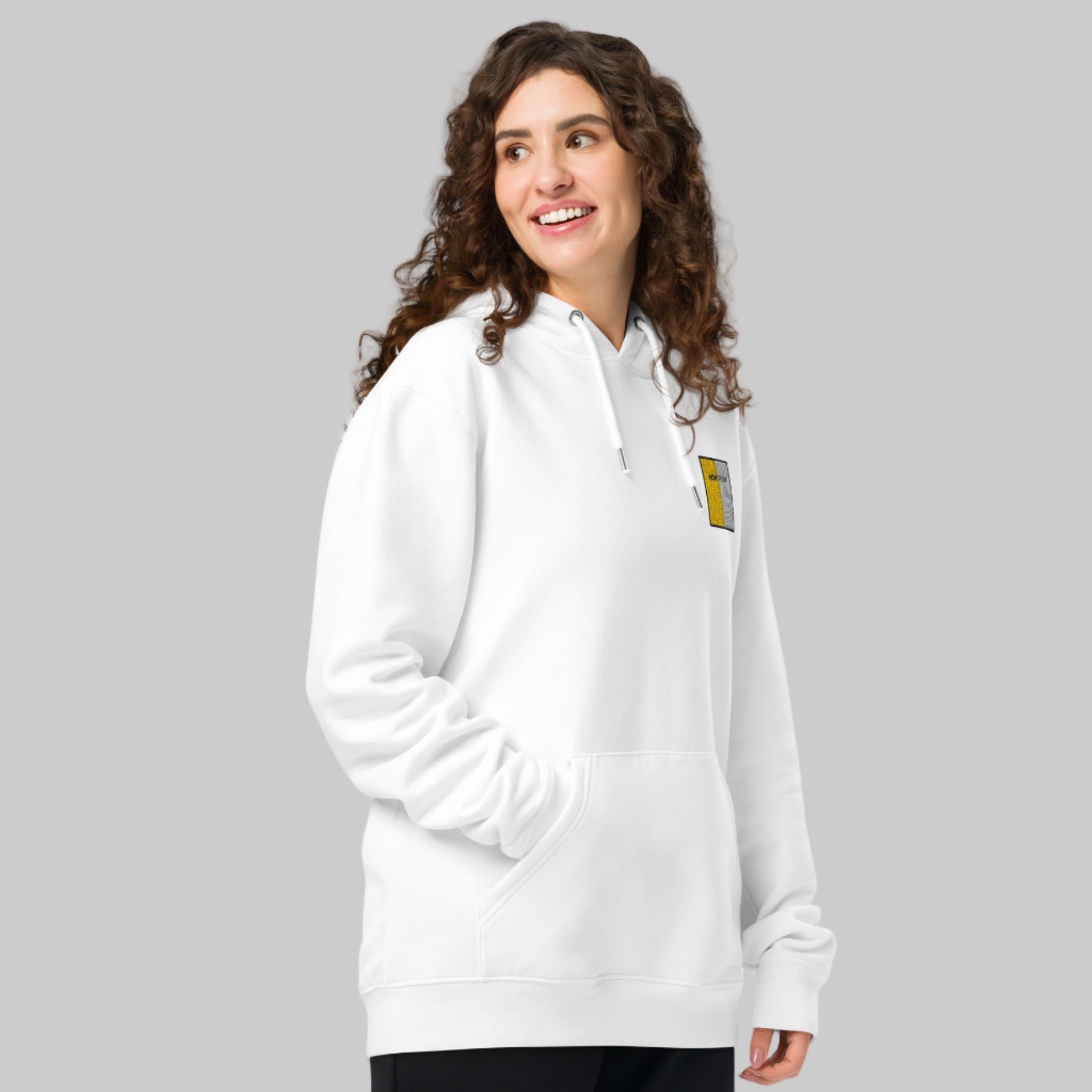 Woman wearing a white hoodie with AONTROIM emblem 