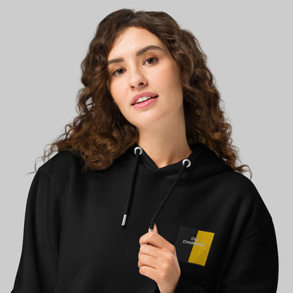 Woman wearing a black hoodie with embroidered CILL CHAINNIGH emblem
