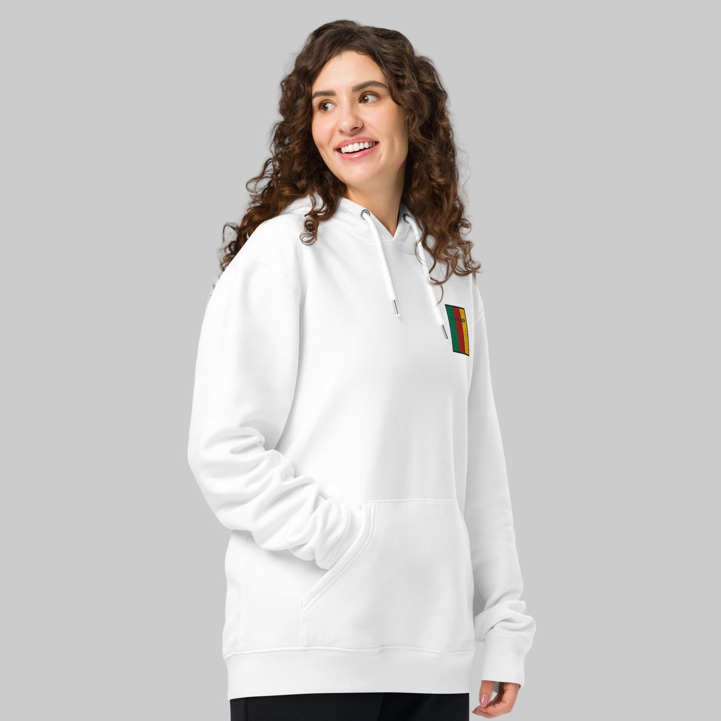 Woman wearing a white hoodie with a Ceatharlach emblem front left