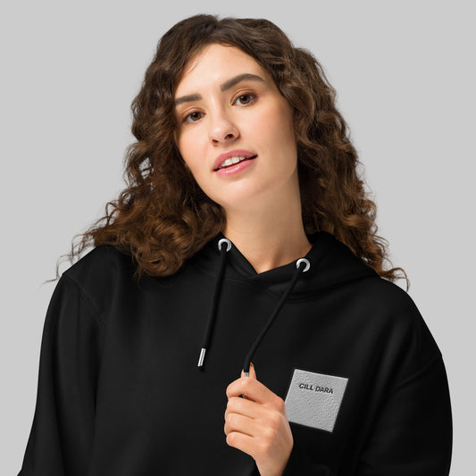 Woman wearing a black hoodie with a CILL Dara emblem