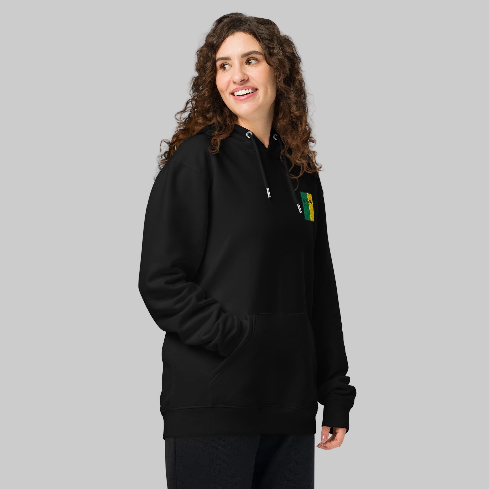 Woman wearing a black hoodie with a Donegal emblem 