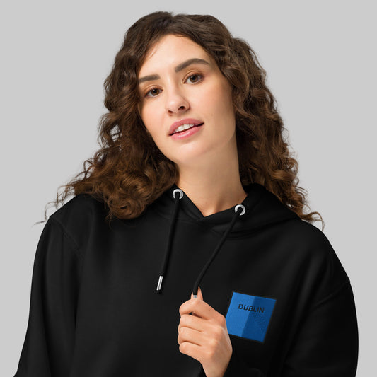 Woman wearing a black hoodie with a Dublin emblem 
