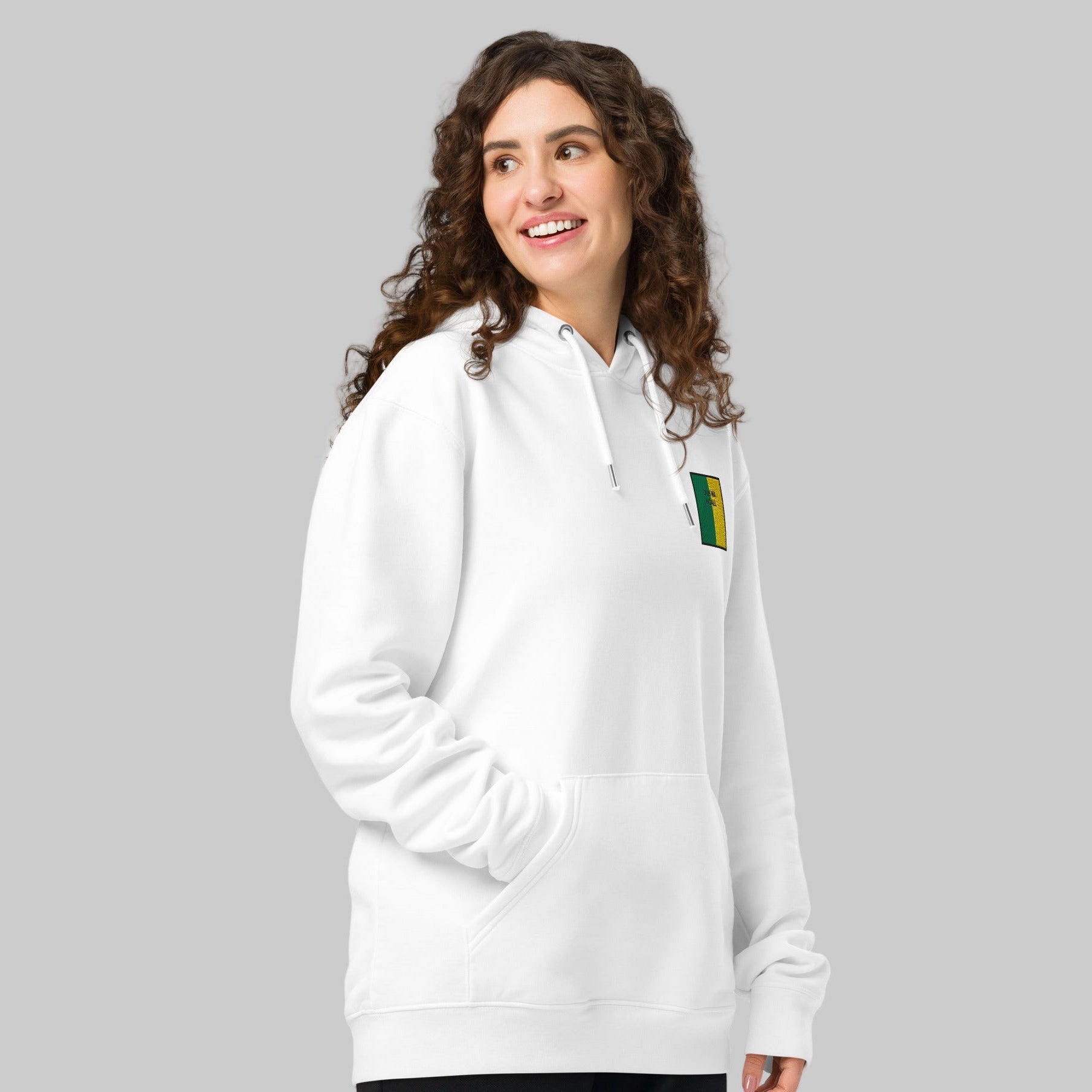 Woman wearing a white hoodie with a dun na NGALL emblem
