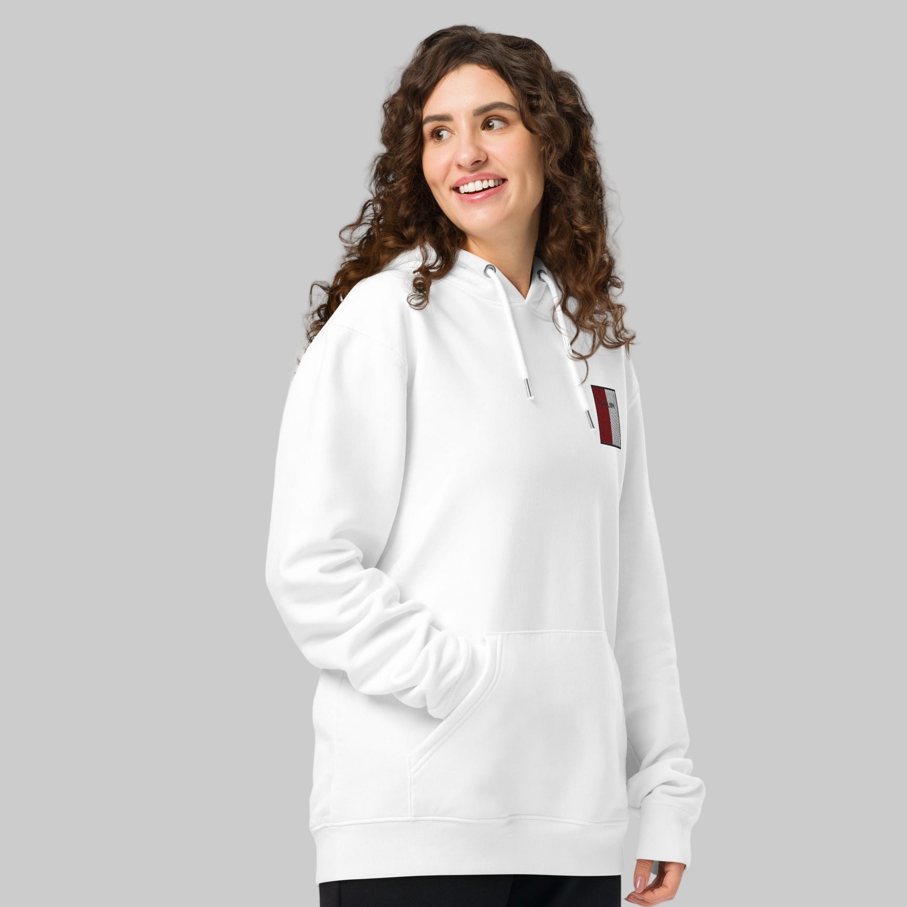 Woman wearing a white hoodie with a GAILLIMH emblem 