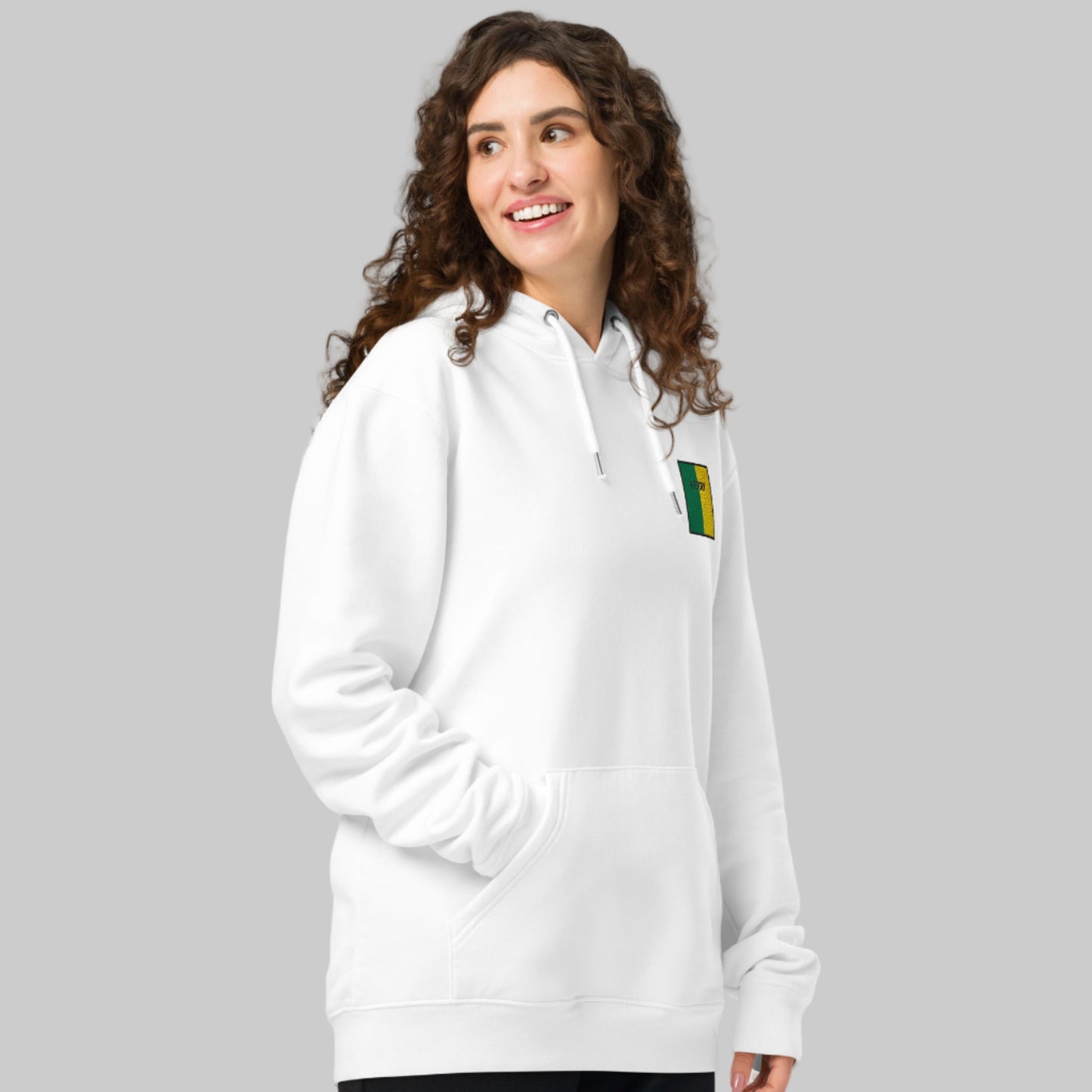 Woman wearing a white hoodie with a Kerry emblem front left 