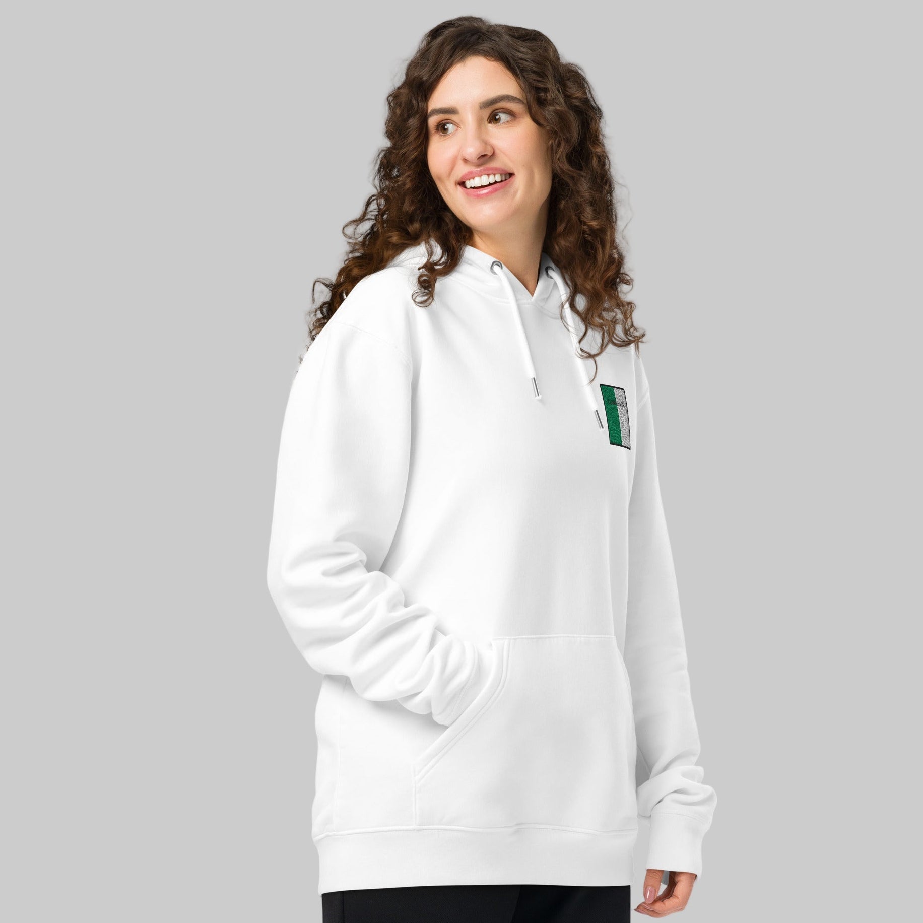 Woman wearing a white hoodie with a LUIMNEACH emblem 