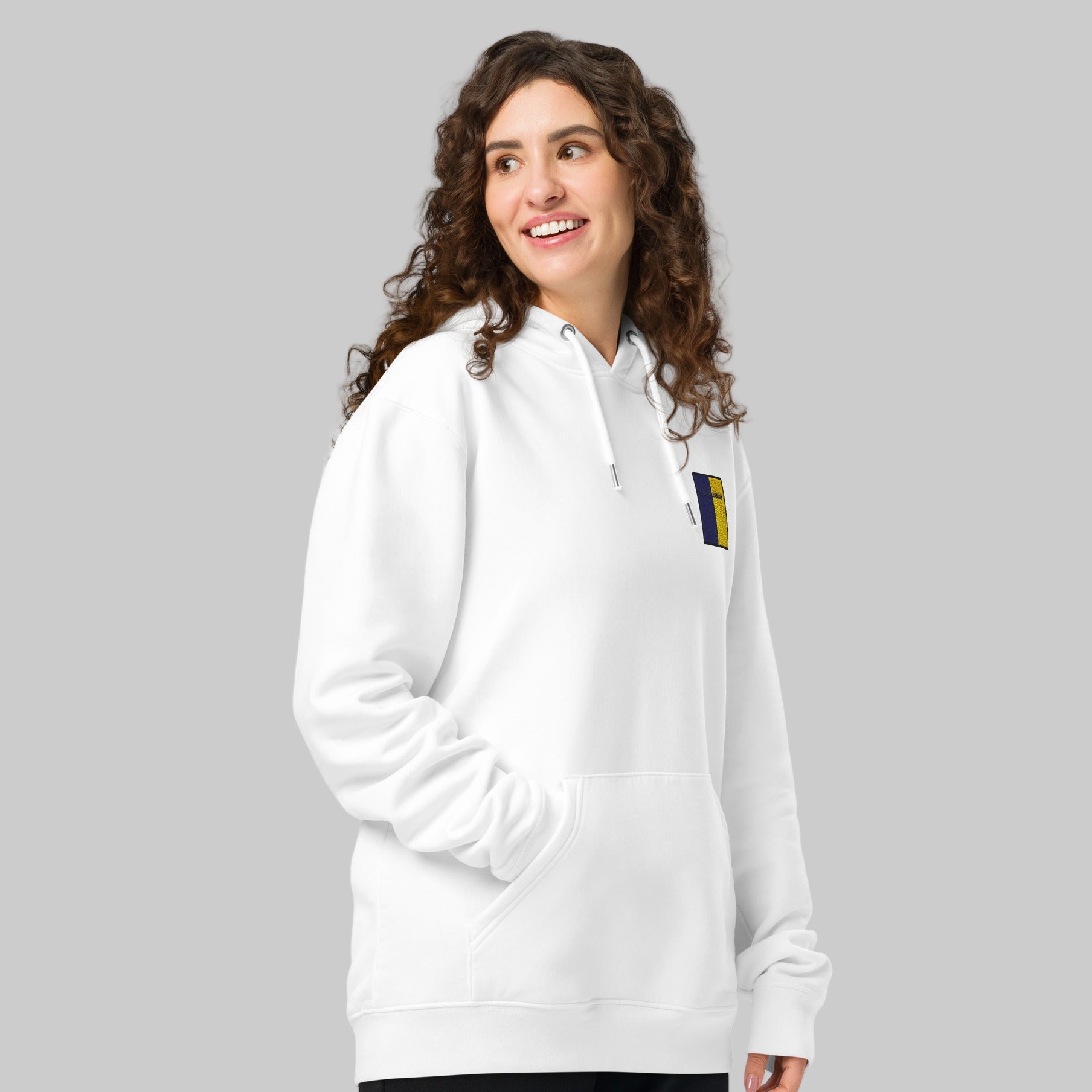 Woman wearing a white hoodie with a loch Garman emblem 