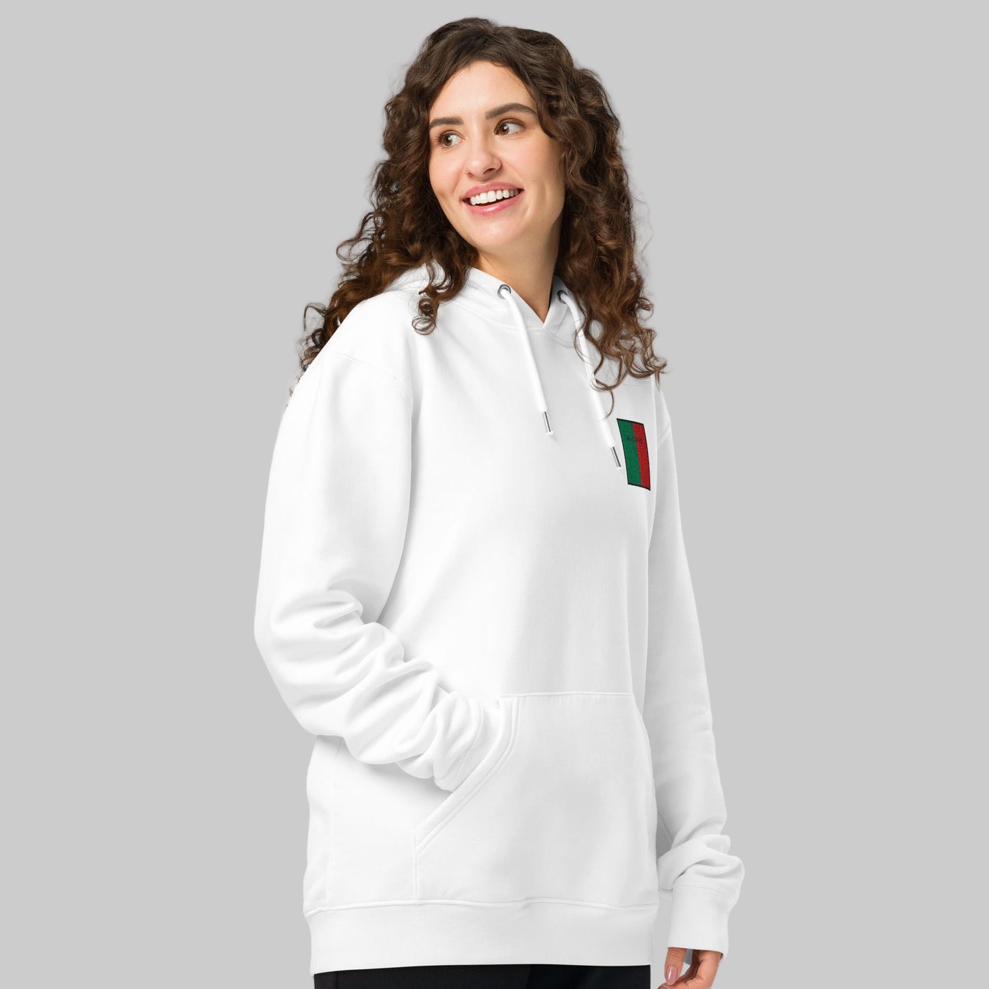 Woman wearing a white hoodie with MAIGH Eo emblem