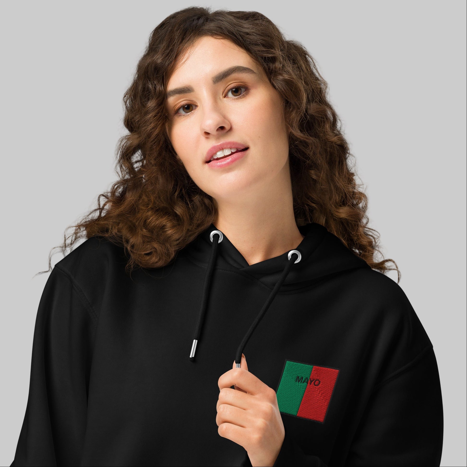 Woman wearing a black hoodie with Mayo emblem 