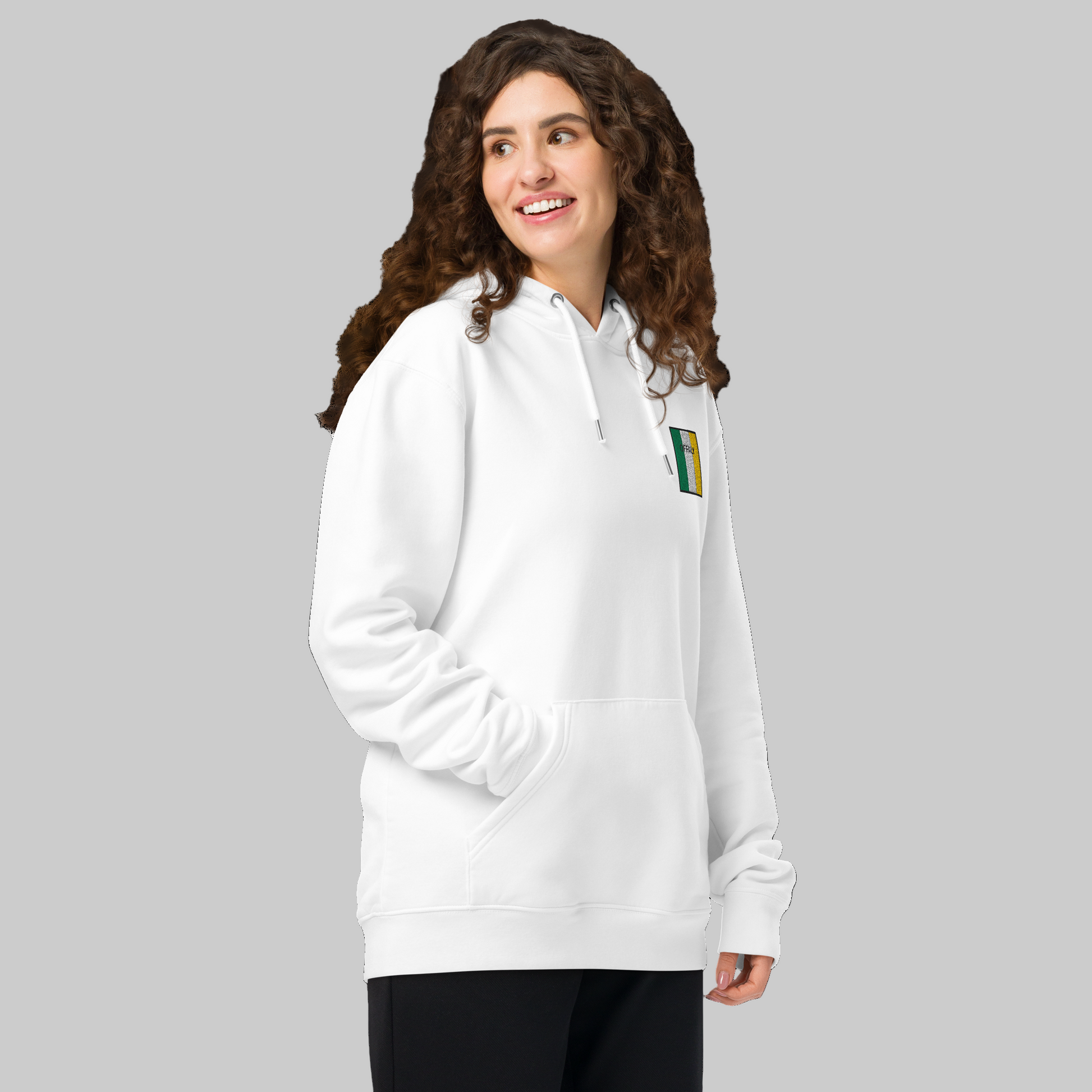 Woman wearing a white hoodie with Offaly embroidered emblem 