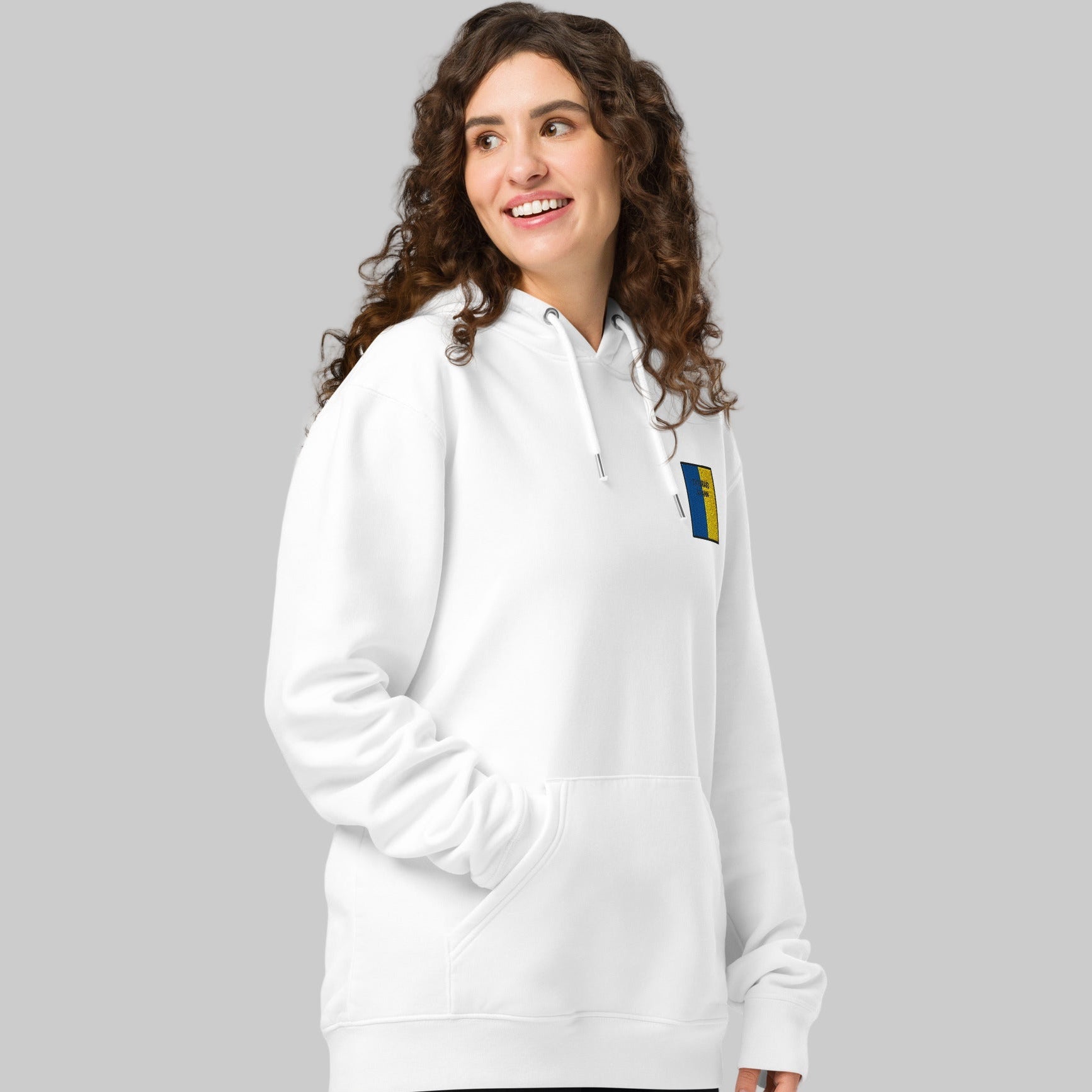 Woman wearing a white hoodie with a TIOBRAID ÁRANN emblem 
