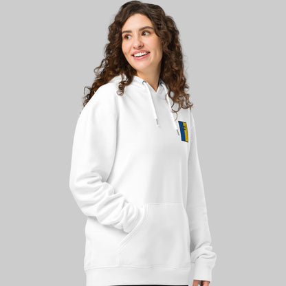 Woman wearing a white hoodie with a TIOBRAID ÁRANN emblem 