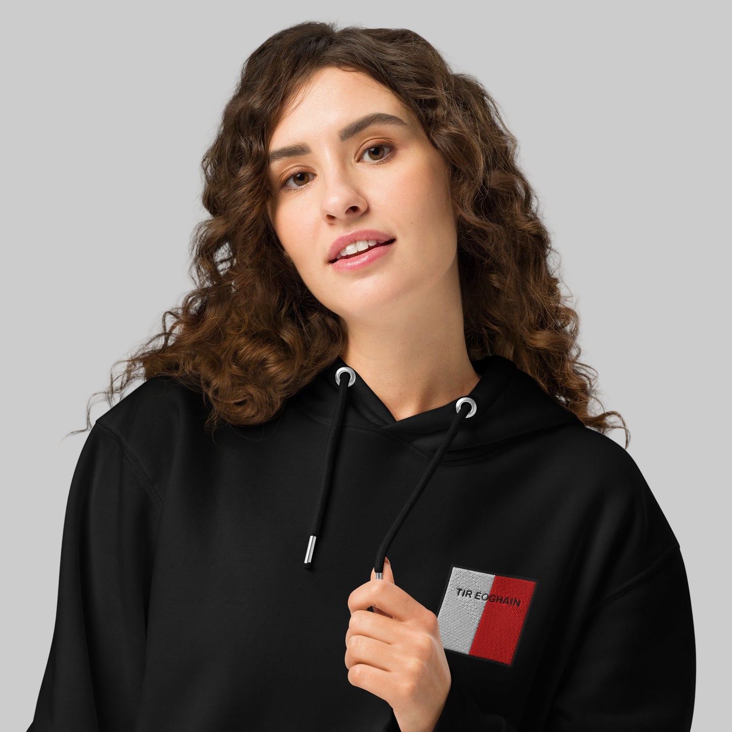 Woman wearing a black hoodie with tir eogh emblem 