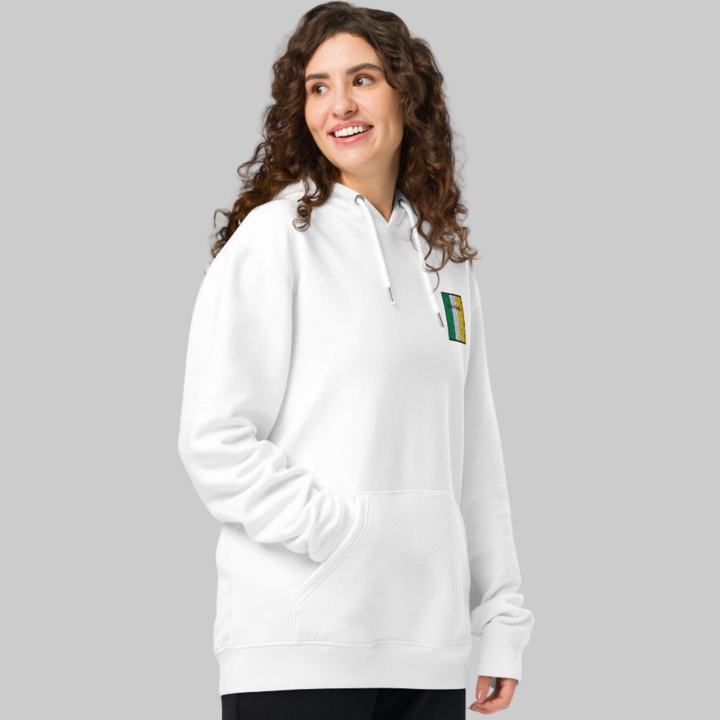 Woman wearing a white hoodie with UIBH FHAILÍ emblem 
