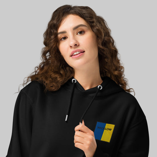 Woman wearing a black hoodie with Wicklow emblem